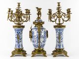 three blue and white vases with a chandelier and a candelier