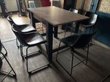 tables and chairs in a room with wood flooring and blue walls