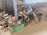 a pile of junk in a garage next to a building