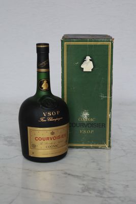 a bottle of liquor sitting next to a box on a table