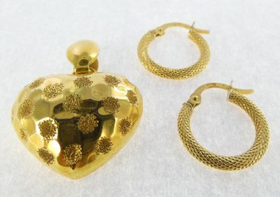 two pieces of jewelry including a heart shaped pendant, hoop earrings, and a ring
