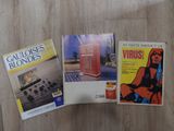 three books sitting on top of a wooden floor next to each other