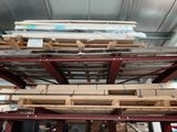many pieces of wood stacked on top of each other in a warehouse