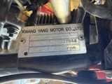 a close up of a motorcycle engine with a tag on it