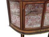 a cabinet that has a glass door on top of it