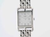 a silver watch that is sitting on a table