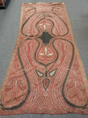an old carpet with a design on it in a room
