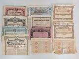several old paper certificates are stacked on top of each other