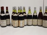 several bottles of wine are lined up in a row on a table