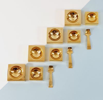 several pieces of gold metal are arranged on a blue and white surface