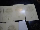 four cards with a design of a skull and a cross on them