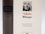 two books sitting next to each other on a white surface