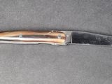 a knife that is laying on top of a table