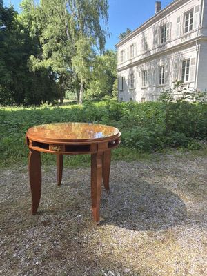 a wooden table with a glass top in the middle of a gravel road