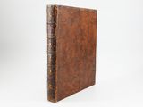 an old book with a brown leather cover on a white background