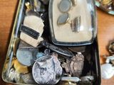 a metal tray filled with assorted items on a wooden table