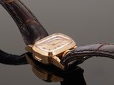 a close up of a watch on a leather strap