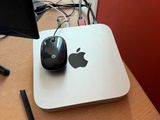 an apple computer sitting on a desk with a mouse and a monitor