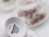 a cup and saucer sitting on a table with other plates