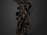 a bronze statue of a woman holding a sword