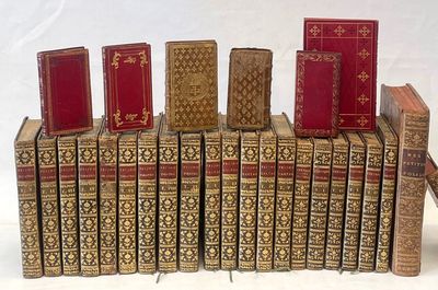 several books are stacked on top of each other on a white surface