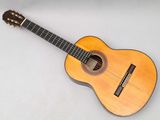 a close up of an acoustic guitar on a white surface