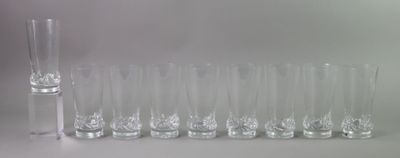 a lot of glasses that are lined up on the table