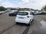 a white car parked in a parking lot next to other cars