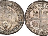 a silver coin with a cross on the front and a shield on the back