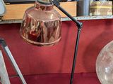 a lamp that is sitting on a table next to a tripod