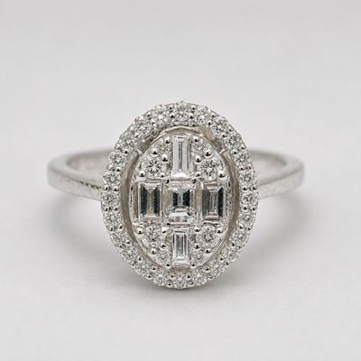 a white gold and diamond ring with a center stone surrounded by smaller diamonds