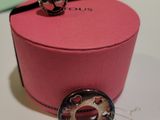 a pink box with a button on it on a table