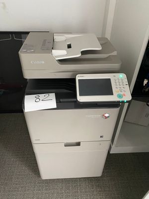 a printer sitting on top of a cabinet next to a printer