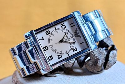 a silver wrist watch with a silver bracelet on it