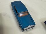 several toy cars are lined up on a white surface
