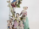 a figurine of a group of people sitting on a tree