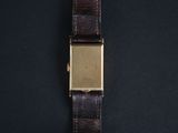 a close up of a watch on a black surface