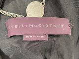 an image of a label on a jacket with a coin attached to it