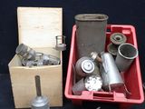 a red box filled with silver items on a black surface