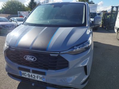 the front of a silver car with a blue stripe on it