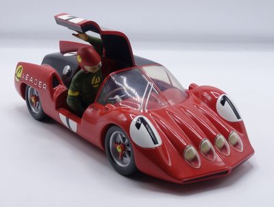 a red toy car with a man sitting in it