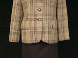 an image of a woman ' s jacket and skirt on a mannequin