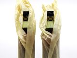 two bottles of wine wrapped in plastic wrappers