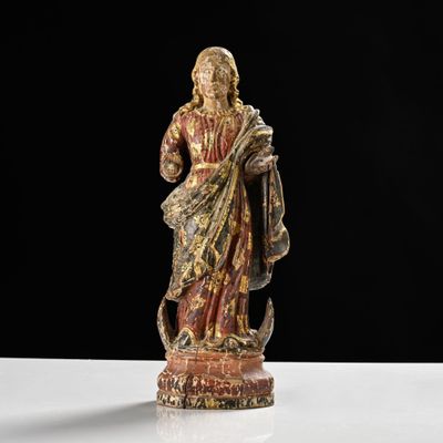 an image of a statue of jesus holding a cross on a table