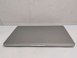 an open laptop computer sitting on top of a white table