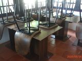 several brooms are lined up on a table in front of a window