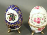 two decorated eggs sitting next to each other on a table