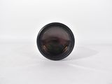 a black camera lens on a white surface