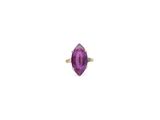 a close up of a purple stone ring on a white surface