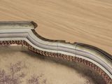a close up view of a chair with a curved back